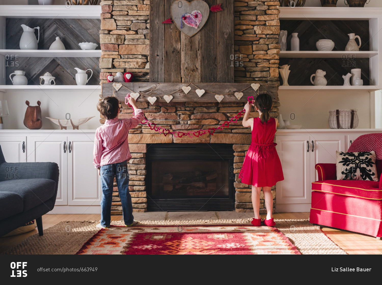 Young boy and sister decorating the fire place for St. Valentine\'s day