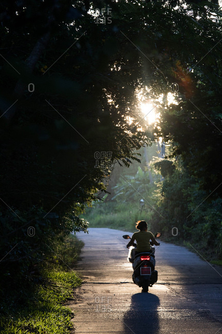 Koh Samui, Thailand - October 6, 2017: Woman riding on motorbike in Koh Samui, Thailand