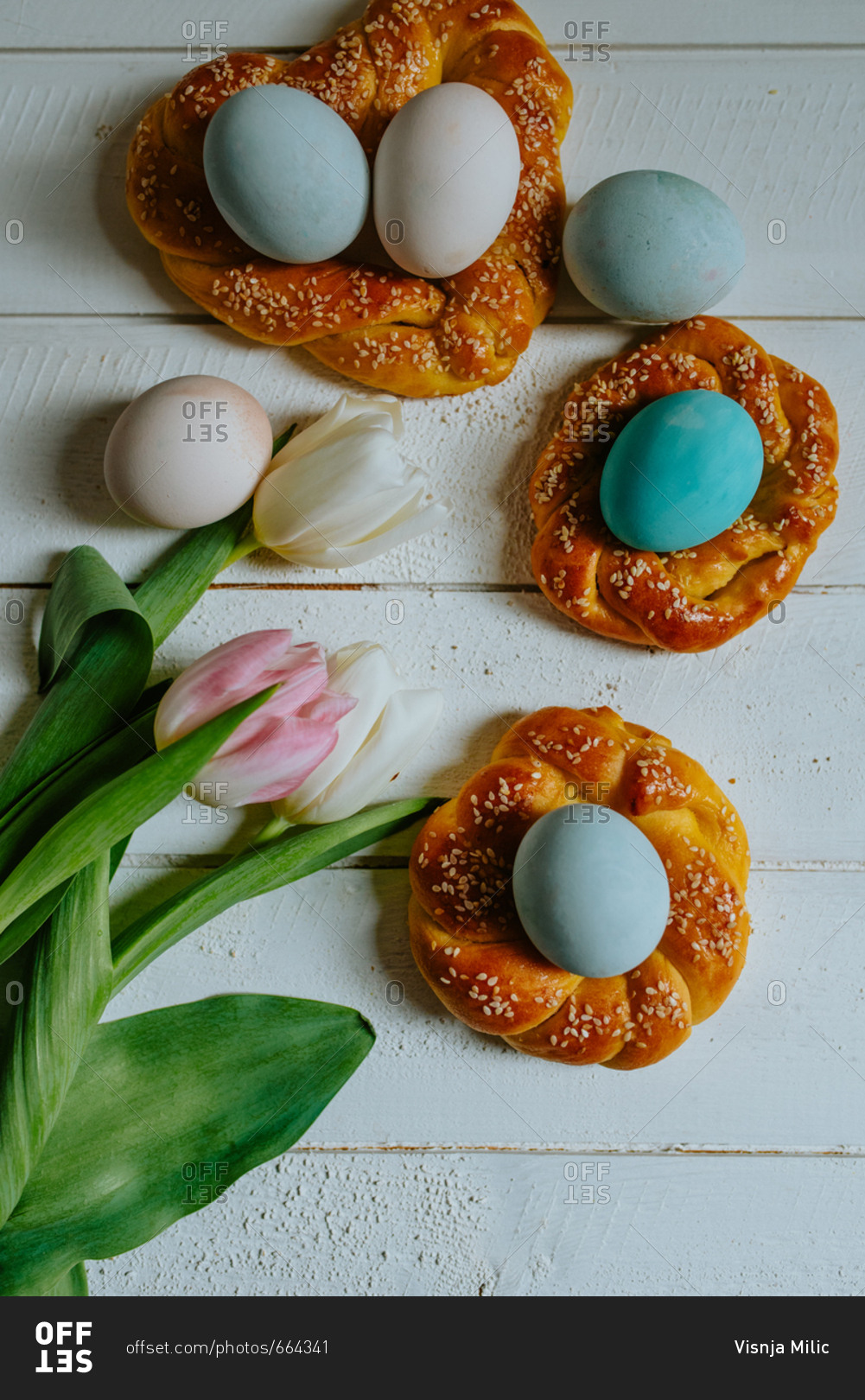 Pastel Easter eggs in braided pastry with tulips next to them
