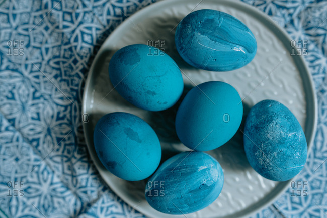 Blue Easter eggs placed on a blue pattern cloth