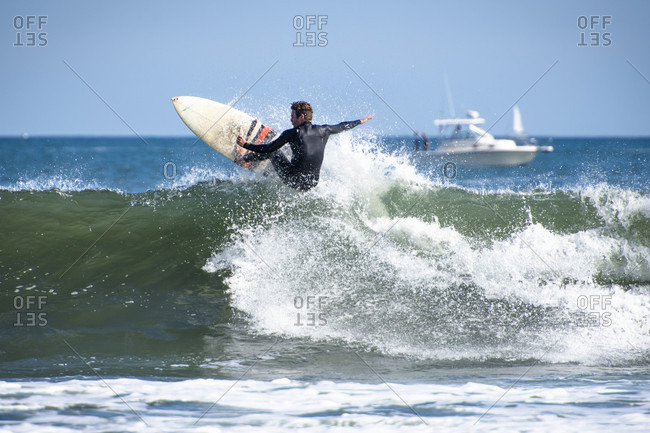 Man surfing hurricane surf, Point Judith, Narragansett, Rhode Island, USA