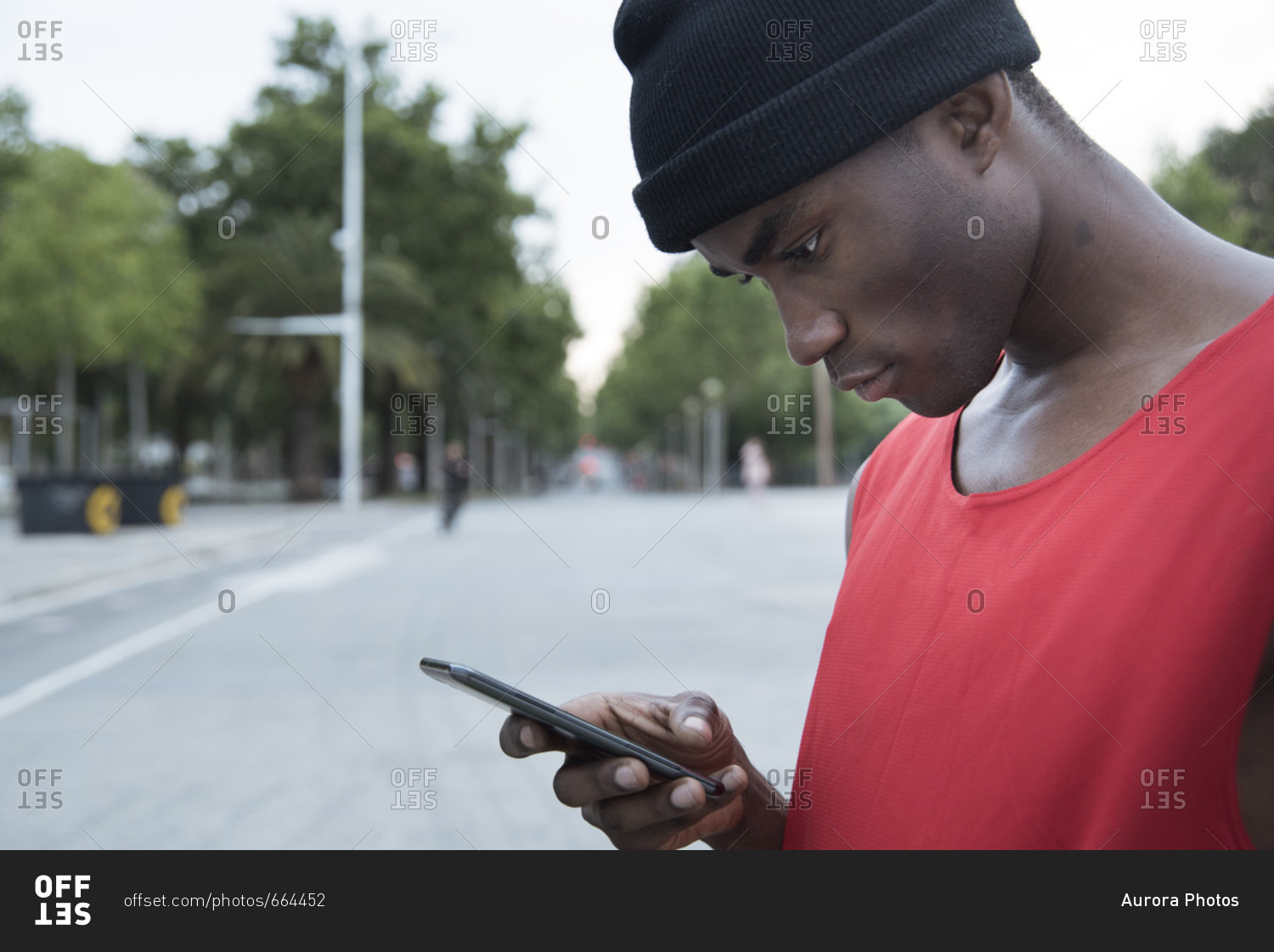 Sportsman in street using mobile phone, Barcelona, Catalonia, Spain