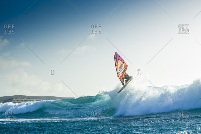 El Cabezo, Tenerife, Spain - July 29, 2016: Professional windsurfer jumping over wave, El Cabezo, Tenerife, Canary Islands, Spain