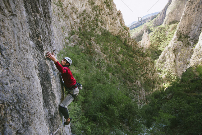 El Potrero Chico, Monterrey, Mexico - December 24, 2014: Man climbing cliff on Cyclops (513a) climbing route of El Portero Chico, Monterrey, Mexico