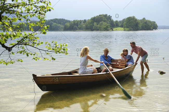 Germany- Bavaria- Murnau- family in rowing boat at lakeshore