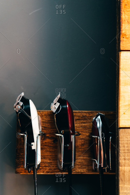 Set of different cutting machines in hangers in barbershop