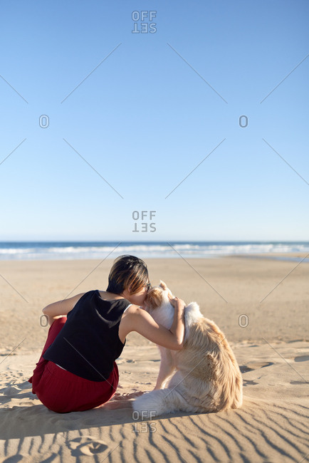 Woman bonding with pet dog, spending quality time outdoors affectionate pet owner