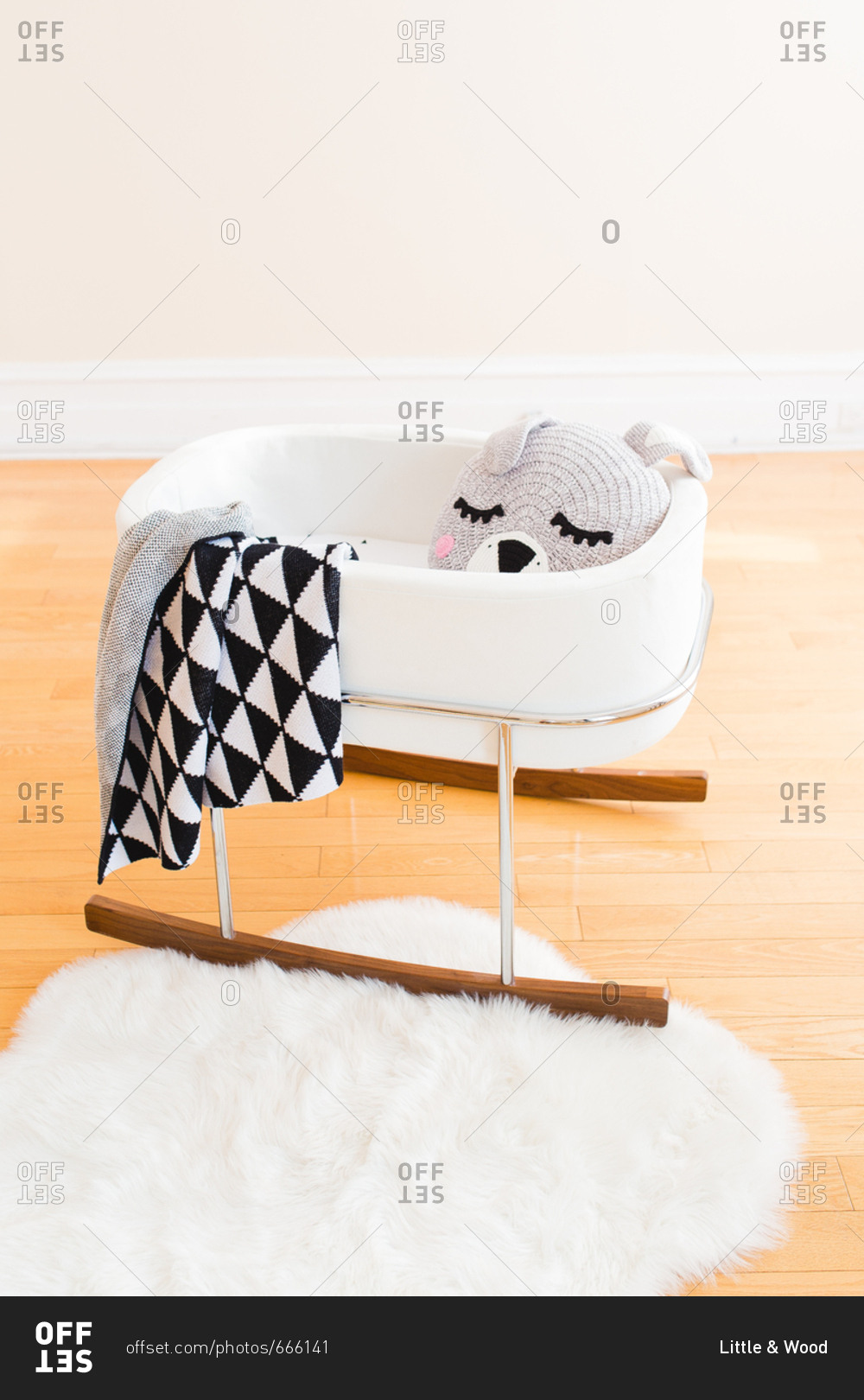 Baby cradle with knit blankets and stuffed animal stock photo OFFSET
