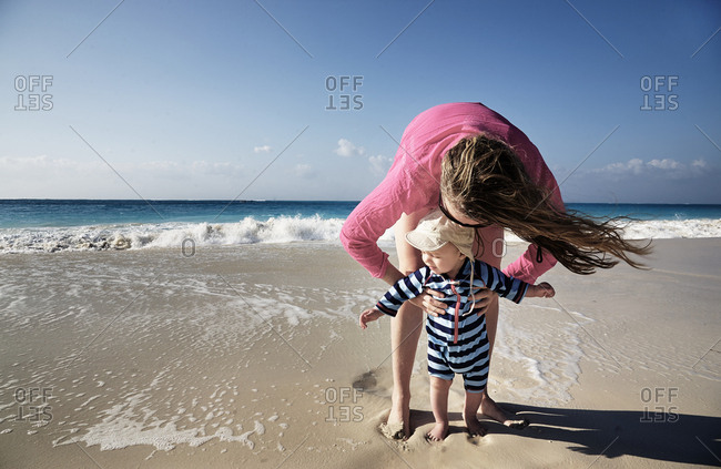 Seven month old baby with mom on beach