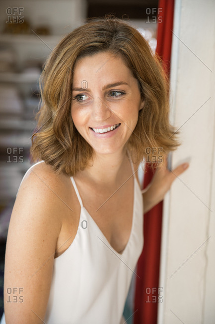 Woman leaning on doorway