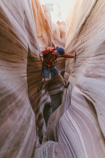 Full length of hiker climbing on canyons