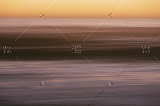 Abstract seascape with horizon over ocean at dusk