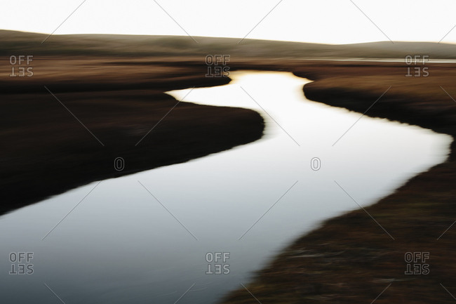The open spaces of marshland and water channels, flat calm water