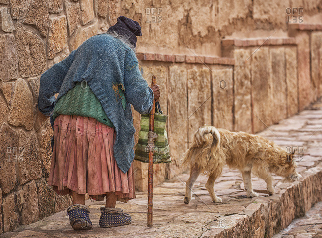 January 16, 2015: An Elderly Woman Walks Down The Cobblestone Sidewalk; Toro Toro, Bolivia