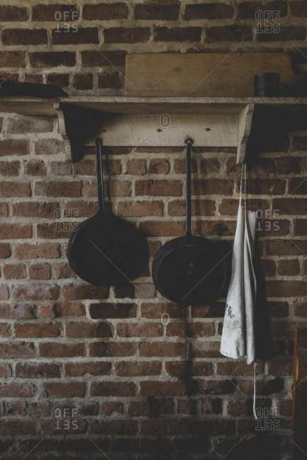 Some pots, pans, and an apron on a shelf in the kitchen at historic Fort Clinch in Fernandina Beach, Florida