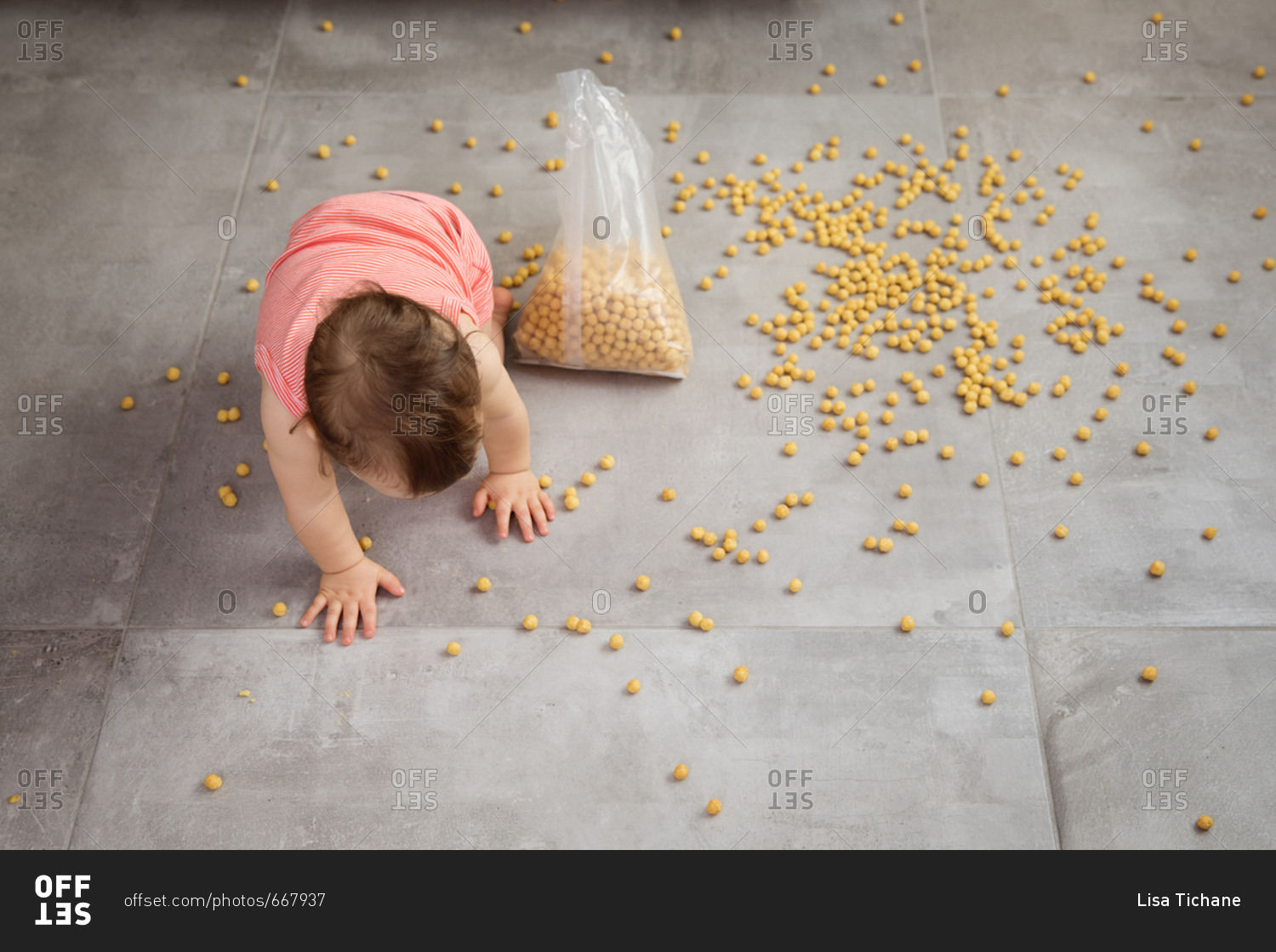 High angle view of baby crawling in spilled cereal