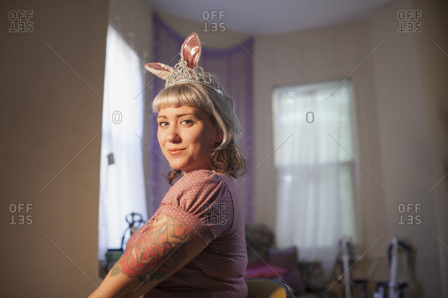 Young woman in front of mirror wearing bunny ears