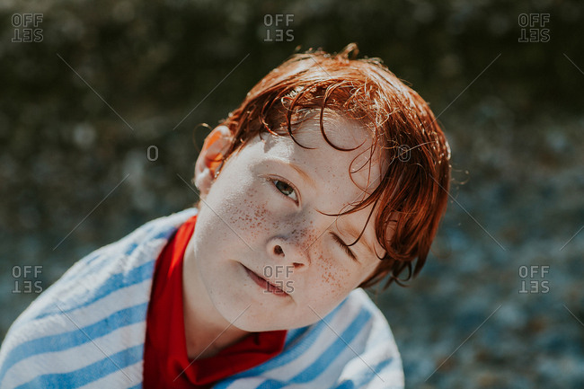 Redhead boy drying off outside in the sun