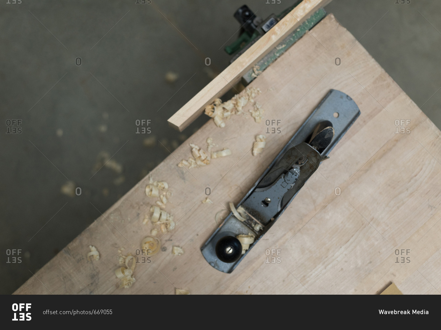 Jack plane with piece of wood on a table at workshop