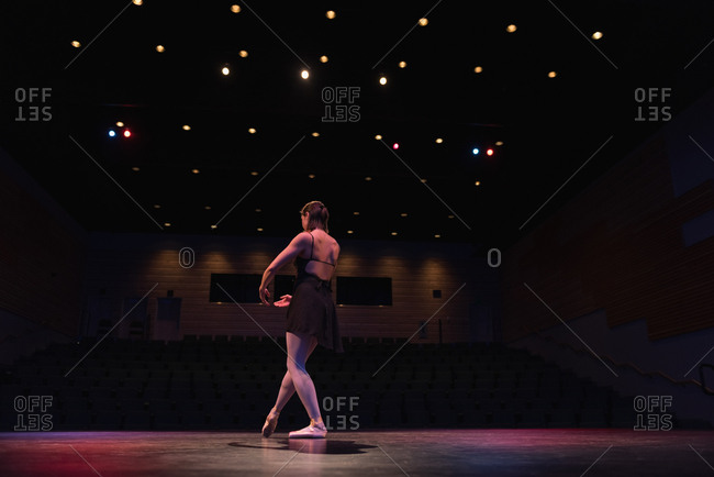 Ballet dancer dancing on stage at theatre