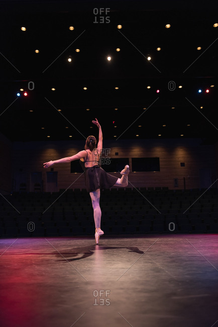 Ballet dancer dancing on stage at theatre