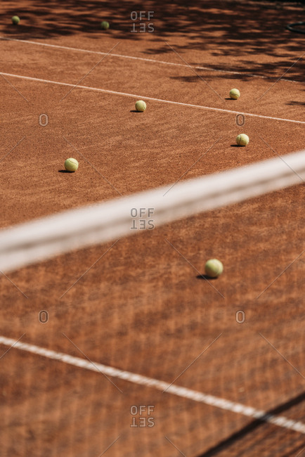 Tennis balls lying on court outdoors