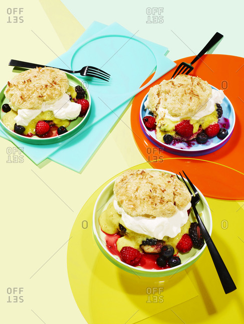 Colorful arrangement of Coconut shortcakes with lime curd and mixed berry compote
