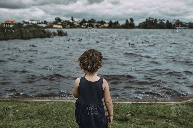 Girl standing near lake, Hamilton, New Zealand
