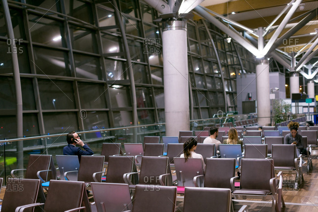Commuters waiting in waiting area at airport