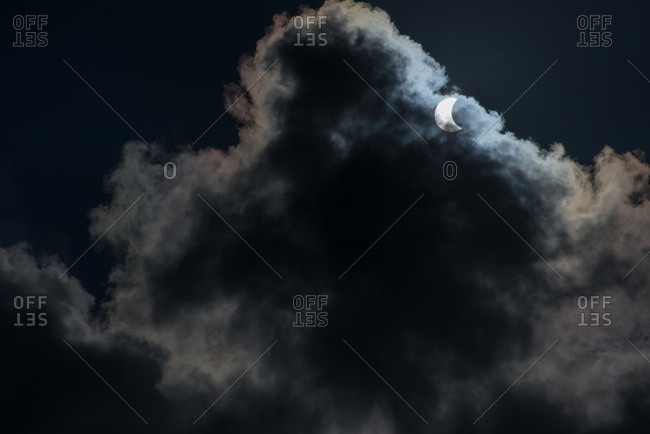 Partial solar eclipse through clouds