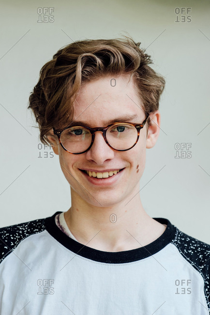 Portrait of cute adolescent wearing retro glasses and smiling