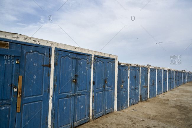 The Port of Essaouira, Essaouira, Morocco; November 8 2017; Blue painted storage cabinets at Essaouira Port, formerly Mogador, Morocco, North Africa, Africa. The Port of Essaouira is not only home to many fishing boats and vessels, it is a popular tourist attraction and has a significant and interesting history attached to it. Fishing is done for local distribution and plays a significant role in the atmosphere and lure to the port.