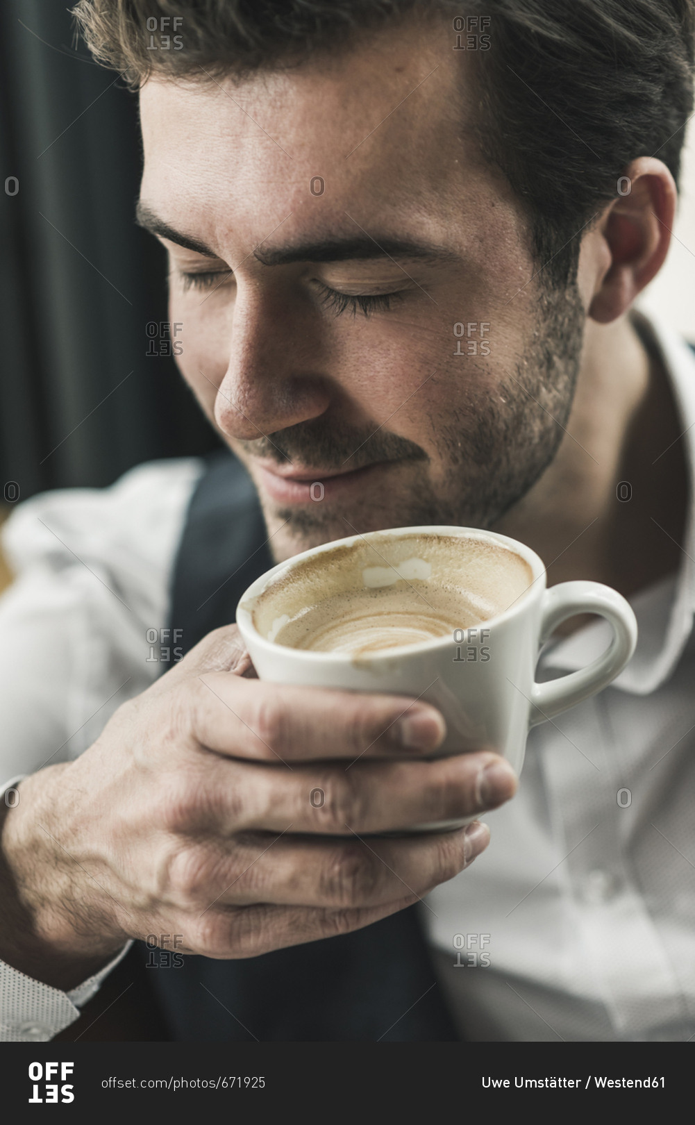 Relaxed young man drinking cup of coffee