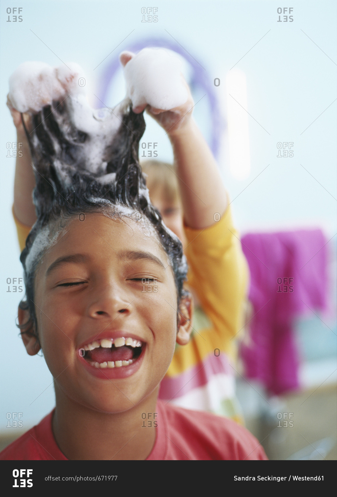 Portrait of laughing little boy with foam in his hair