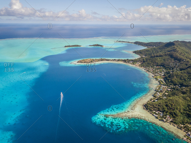 Aerial view of a boat in the bay of Bora-Bora, French Polynesia.