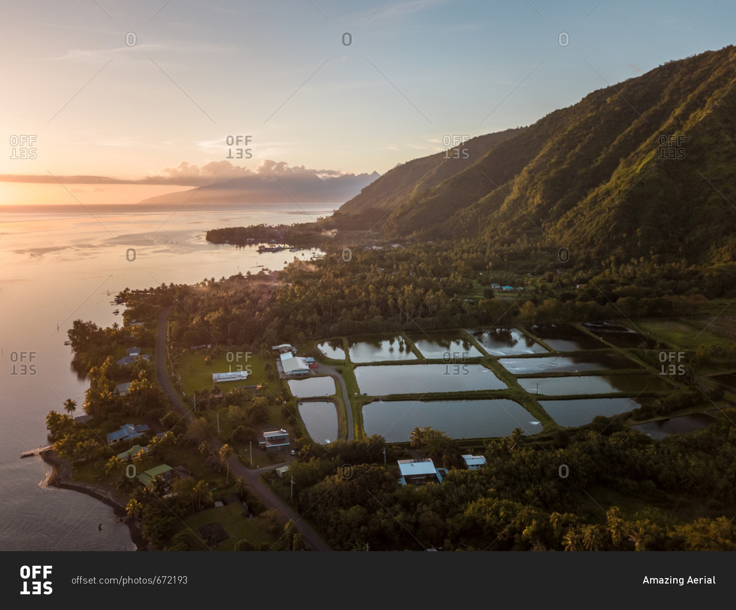 Aerial view of Tahiti coastline at sunset in French Polynesia.