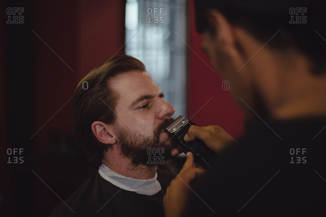 Man getting his beard trimmed with trimmer