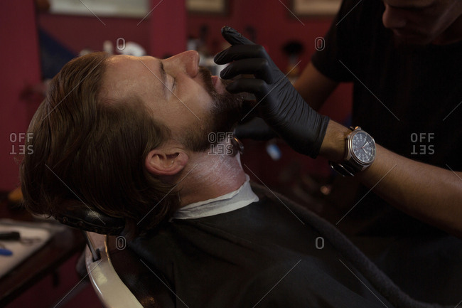 Man getting his beard shaved with trimmer