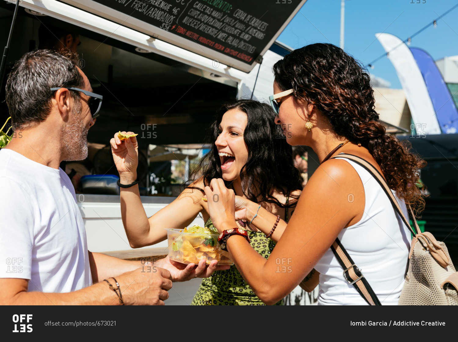 People eating snacks at food truck