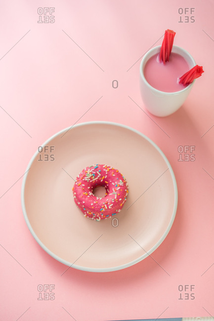 Sweet pink doughnut and sweet pink drink with jelly candies