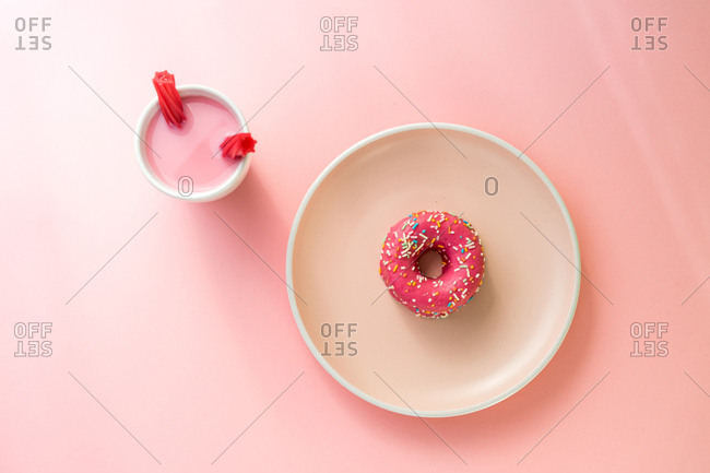 Sweet pink doughnut and sweet pink drink with jelly candies