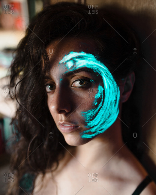Woman with luminous paint on face
