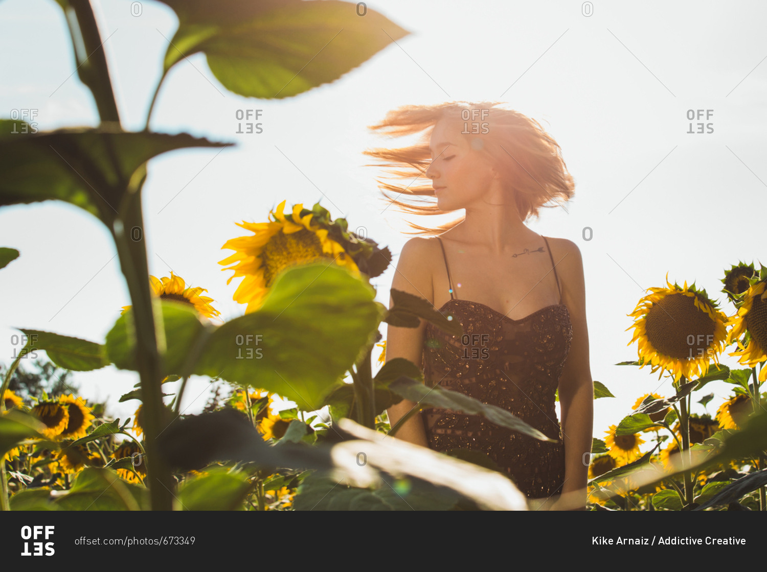 Pretty young woman in sunflowers