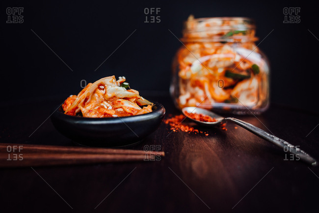 Kimchi in the white plate and black chopsticks on the red background.Top  view.Copy space. Stock Photo | Adobe Stock