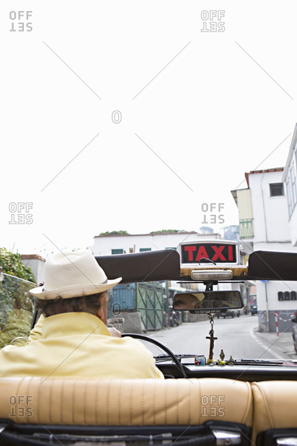 Rear view of man driving a taxicab in Capri, Italy