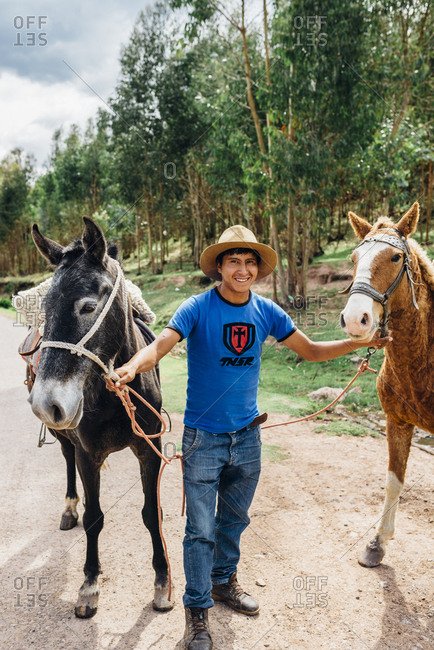 Cuzco, Peru - November 21, 2017: Inca man in hat with two horses