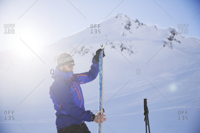 Austria- Tyrol- Kuehtai- freeride skier preparing ski for a ski tour