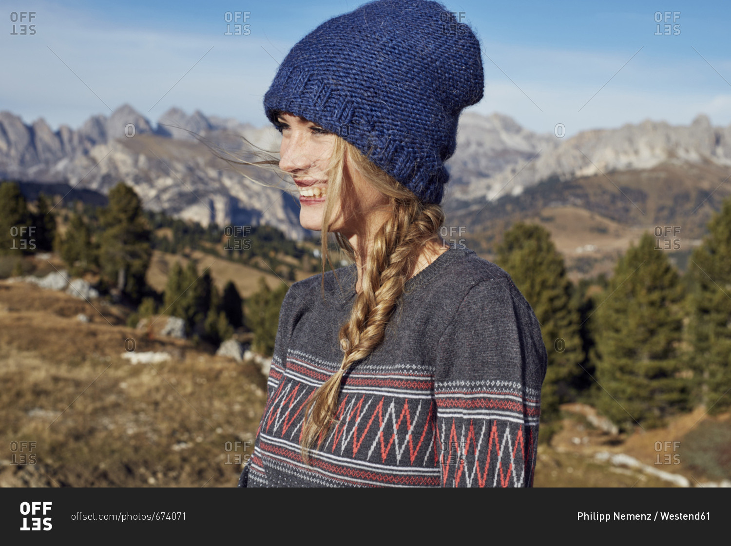 Portrait of happy young woman hiking in the mountains