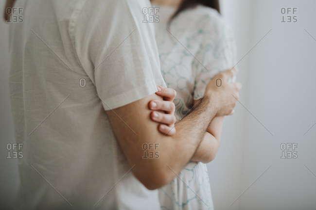 Couple standing face to face holding each other