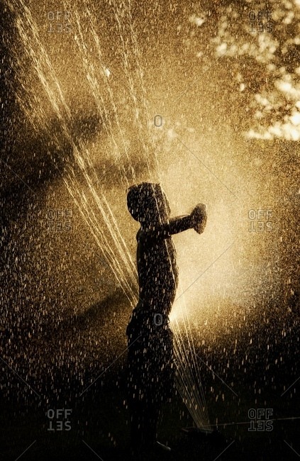 St. Albert, Alberta, Canada - June 24, 2005: Playing In The Sprinkler